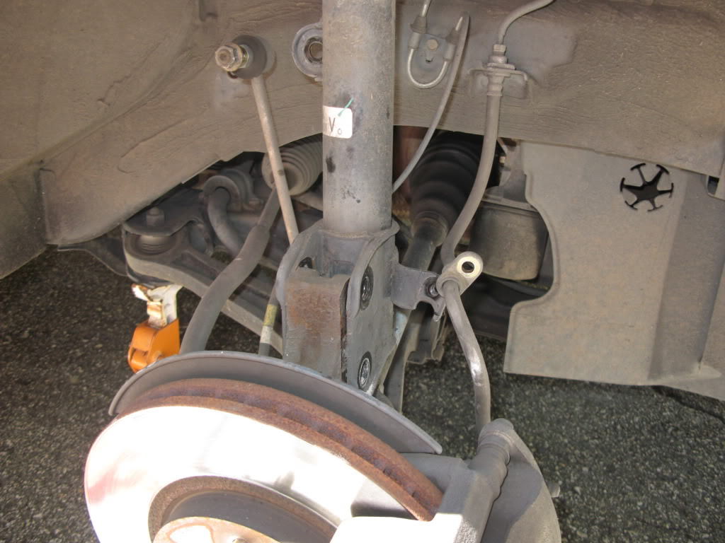 Disconnect brake line, speed sensor, and sway bar from the strut