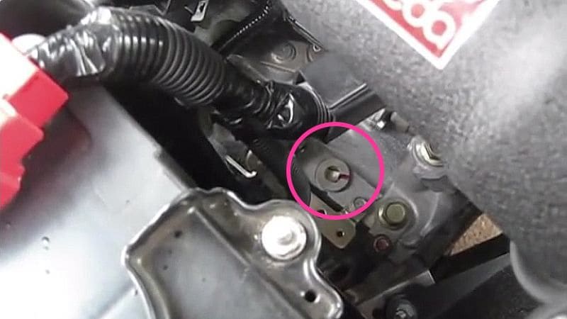 The transmission fill plug is just behind the battery near the bottom of the engine bay