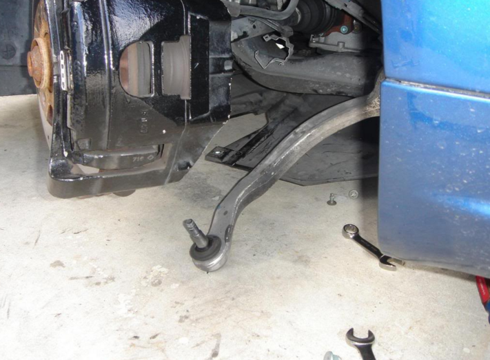 Pry the rear lower control arm ball joint off and replace the arm