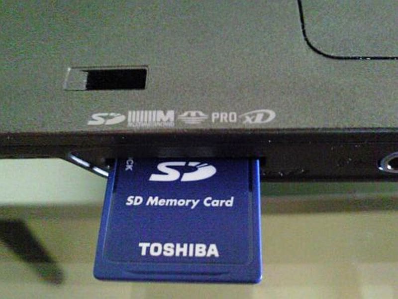 Most laptops come with an SD card reader, or add one that plugs into a USB port