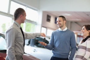 receiving car keys from salesman