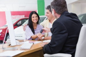 couple at dealership with salesman