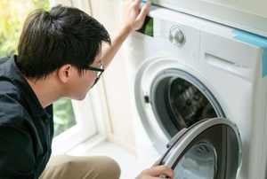 Person looking inside an open dryer
