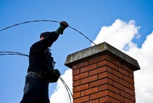 A man works on a chimney.