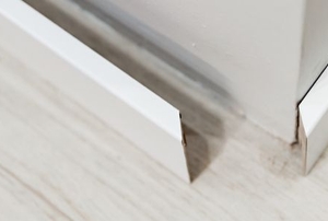 loose base board on wall and floor corner