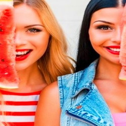 two girls with watermelon slices