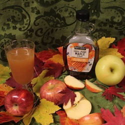 Maple syrup and apple cider with autumn leaves