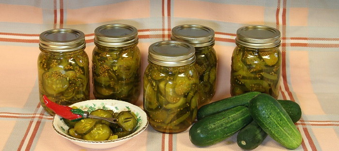 jars of pickles, cucumbers and bowl of pickles