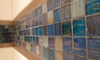 Blue, glass wall tile decorating a bathroom.
