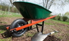 A wheelbarrow and shovel ready for lawn repair.