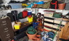 A cluttered mess takes over the space inside a garage.