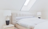 a skylight in a white bedroom