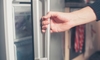 Opening the door of an upright freezer