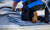 worker on roof replacing asphalt shingles