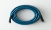 A dark blue garden hose coiled up