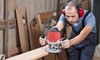 A DIYer using a router on a piece of lumber in a workshop.