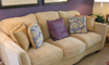 beige couch with throw pillows