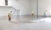 applying sealant to a concrete floor in a large building