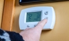 A digital home thermostat on the a wall.