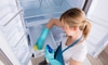 A woman cleaning a refrigerator