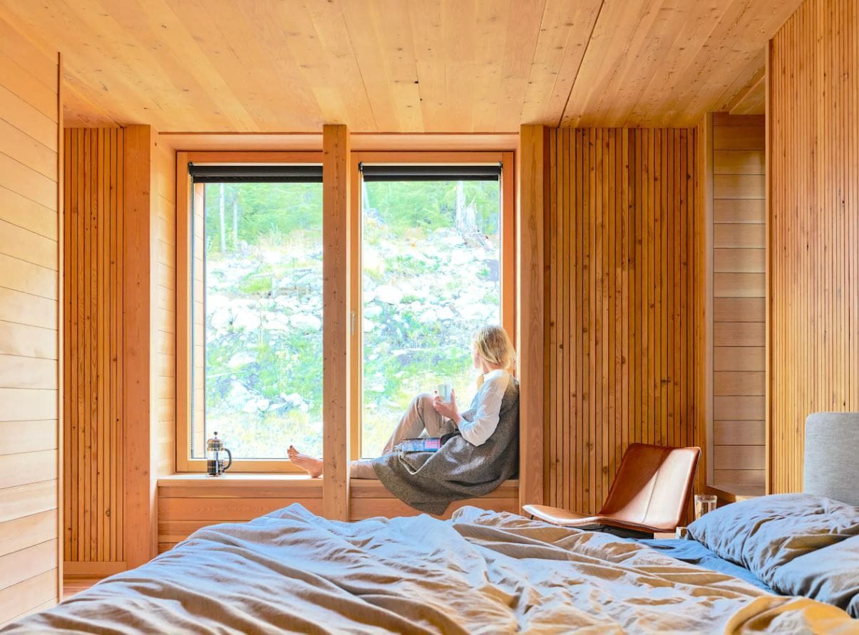 woman in window in wood bedroom