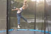 child jumping on a trampoline