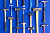 An array of hammers on a blue background.