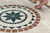 Bare feet on a mosaic tile floor.