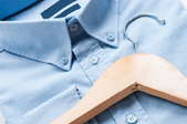 men's crisp button-up shirt and wooden hanger