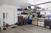A cluttered garage being used for storage.