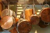 Pots and pans hanging on a rack. 