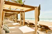 Row of outdoor canopy beds on the beach
