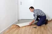 A man installs linoleum floors.