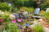 Pond surrounded by seating and colorful plants