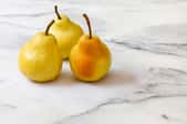 Three pears on a marble counter