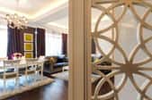 wood room divider with circular designs in fancy dining room