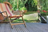 Chair on decking with landscaped yard in the background