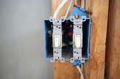 double light switch installed on framing of a wall