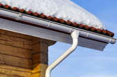 gutter, downspout, and snowy roof
