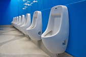 row of urinals in a bathroom