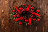 A Christmas wreath with red accents.