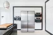 Modern kitchen space with stainless steel refrigerator