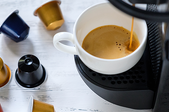A Keurig coffee machine brewing coffee into a mug