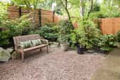 Outdoor sitting area with plants and privacy fence