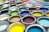 Rows of open paint cans in a variety of colors
