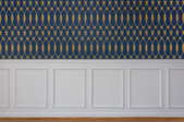 Wall with wallpaper on upper and wainscoting on lower.
