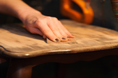 A woman works on a table.