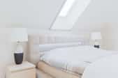 a skylight in a white bedroom