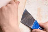 hands removing wallpaper