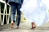 a bride and groom in bare feet